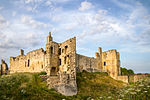 Warkworth Castle curtain walls with Gateway, towers and attached buildings