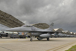 An F-16 Fighting Falcon of the South Carolina Air National Guard's 169th Fighter Wing taxiing past aircraft shelters at McEntire JNGB