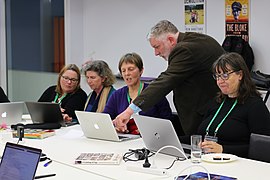 Editors discussing Wikipedia updates at Edit for Equity event in Wellington, New Zealand.