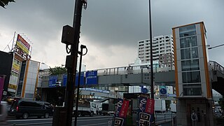 A footbridge with elevators on each corner of a four-way intersection in Tokyo