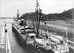 The first ship to transit the canal at the formal opening, SS Ancon, passes through on 15 August 1914
