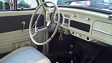 The white cockpit of a 1960s automobile.