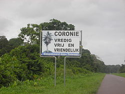 Translation of the sign: Coronie: peaceful, free and friendly