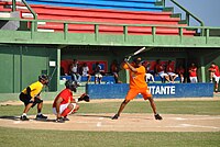 Rentería holding a bat over his shoulder while wearing an orange uniform.