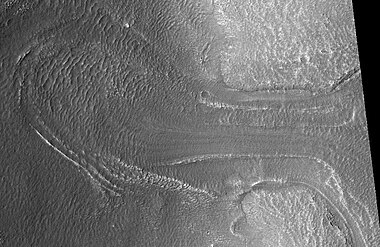 Probable glacier as seen by HiRISE under HiWish program Radar studies have found that it is made up of almost completely pure ice. It appears to be moving from the high ground (a mesa) on the right.