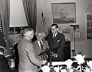 U.S. President Harry S. Truman (left) receiving a hanukkiah in the Oval Office as a gift from Israeli Prime Minister David Ben-Gurion (center) alongside Israel's Ambassador to the U.S. Abba Eban (right), 1951