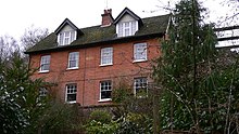 four-bay red-brick two-storey house with roof dormers