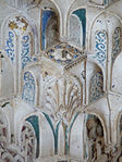 Extreme close-up of carved and painted details in constituent niches of a muqarnas dome in the Sala de los Reyes in the Alhambra
