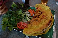 Photo includes tomatoes, carrots and radishs, cucumber, herbs and lettuce, as well as dipping sauce.