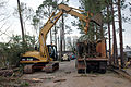 Caterpillar 315C L Excavator cleaning up tornado debris