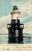 Greens Ledge Light stands in open water about 10 feet (3.0 m) deep, about 1 km from land