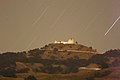 night view of Lick Observatory on Mt Hamilton from Grant County Park showing open dome with telescope, stars track across sky in long exposure, Jun 25, 2005