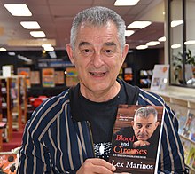 Portrait of Morinos holding his book, Blood and Circuses