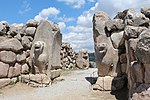 Stone gate with sculpted lions.