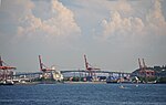 An arching concrete bridge near a port