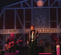Country music singer Bill Anderson, singing on the stage of the Grand Ole Opry