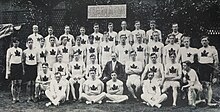 Black and white photo including four rows of athletes wearing white sweaters with a maple leaf crest