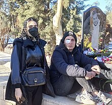 From left to right, Kimia Zand and Ali Zare, both wearing black, Kimia wearing a black face mask. Both in winter clothes.