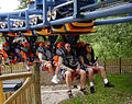 A Vekoma Suspended Looping Coaster train seats riders 2 across.