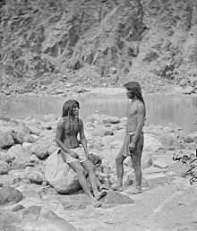 A black and white photograph of two Mohave men next to the Colorado River, 1871