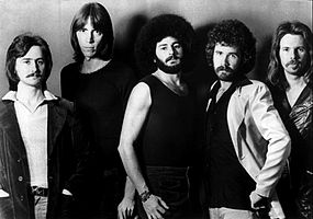 1976 black-and-white photo of the American rock band Boston for their self-titled debut studio album Boston. From left to right guitarist Barry Goudreau, band leader Tom Scholz, drummer Sib Hashian, singer Brad Delp, and bassist Fran Sheehan.