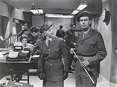 Carmichael and Jill Adams dressed in army uniforms on the set of an office