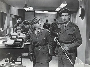 Carmichael and Adams dressed in army uniforms on the set of an office
