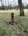 Hydrant from the former Husum-Schwesing sub-camp (with steles in the background)