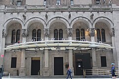 The hotel's main entrance, a set of five arches, with a metal-and-glass canopy above them