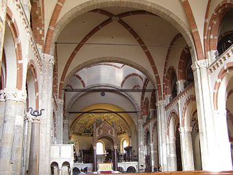 The Church of Sant'Ambrogio, Milan, has domical ribbed vaults and a contrasting red brick and stone.