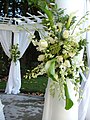 A "flower spray" bouquet attached as decor to a pillar.