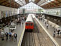 A train is departing at from a station in the Royal Borough of Kensington and Chelsea in London.