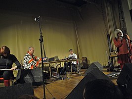 Throbbing Gristle performing in 2009. From left to right: Cosey Fanni Tutti, Peter Christopherson, Chris Carter, Genesis P-Orridge.