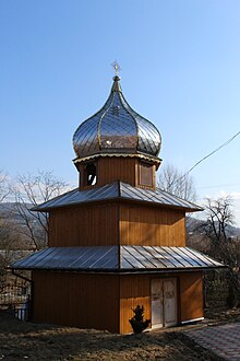 The two-tiered wooden bell tower of the 18th-century Church of the Nativity of the Blessed Virgin Mary in the village of Mshanets. Ukrainian Greek Catholic Church.