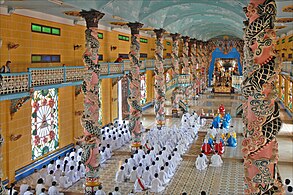 Cao Dai followers doing worship in the Holy See Temple