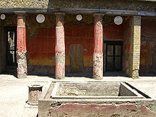 bassin carré devant trois colonnes rouges