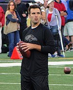 Joe Flacco with the Baltimore Ravens hands-off the ball during a game.
