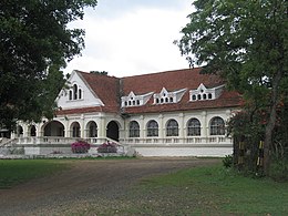 Exterior of a long, white colonial-style building