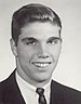 A black and white headshot image of Morgan in a suit and tie with no hat.