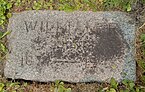 Flat grey granite marker engraved with the name William F, and the years 1877–1945