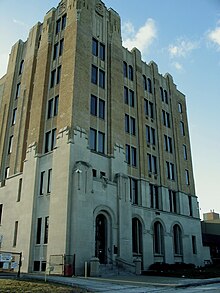 A five-story Art Deco 1920s building with buff brick and stone facing