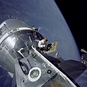 David Scott stands in the open hatch of Apollo 9, by NASA/Rusty Schweickart (edited by Coffeeandcrumbs)