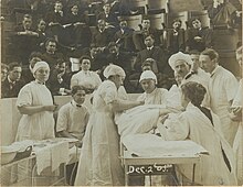 An audience attending a surgical procedure overseen by Dr Bertha Van Hoosen.