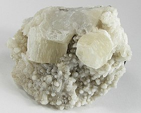 Two sharp pseudohexagonal crystals of witherite on calcite from Hardin County, Illinois (size: 6.4 × 5.4 × 3.4 cm)