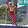 Hélio Castroneves climbs the fence to celebrate his win in 2012.