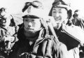 A kamikaze pilot ties a hachimaki on his fellow pilot