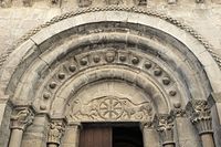 Tympanum of the west portal, showing chrismon and lions