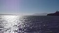 A view of the Golden Gate Bridge from the bay during a hazy afternoon.