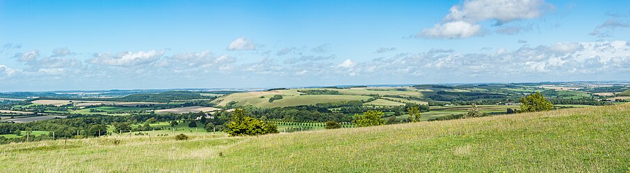Panorama at Win Green showing a patchwork of rolling hills with pastures and scattered woodlands along the northern chalk escarpment of Cranborne Chase above the Vale of Wardour.