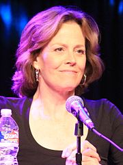 A smiling, casually-dressed Sigourney Weaver